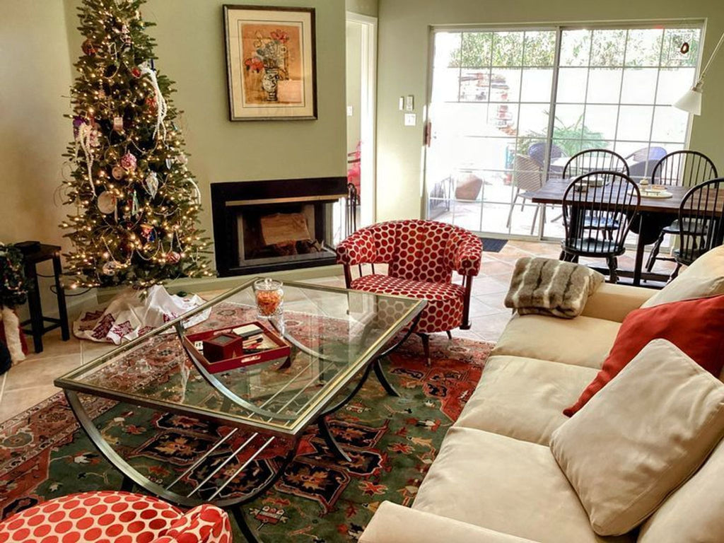 a living room with a couch, coffee table, and christmas tree.