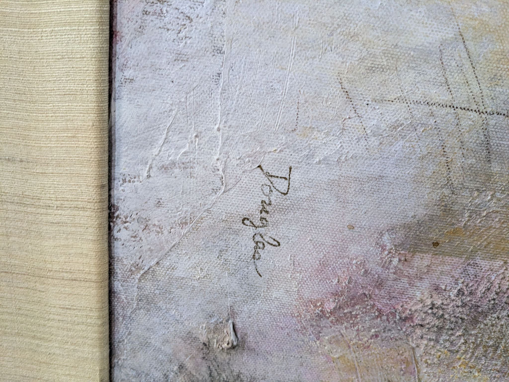 Close-up of a textured canvas signed by the artist, Douglas, with subtle colors.