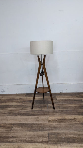 Reperch wooden floor lamp with tripod base and beige lampshade.