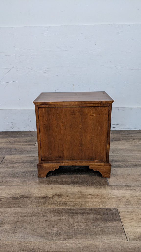 Back view of an Ethan Allen wooden end table showing its plain wooden finish.