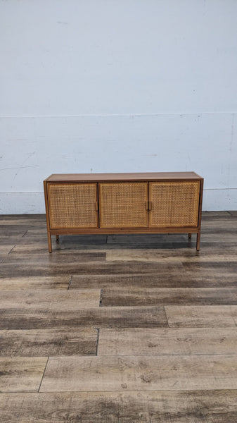 TV stand with mesh-detailed cabinet doors, natural brown finish.