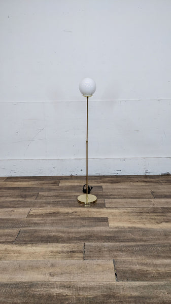 Elegant floor lamp with a gold stand and white globe shade by Reperch.