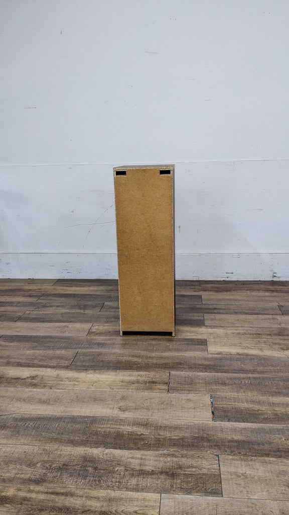 Back view of IKEA Malm dresser showing its wooden panel.  