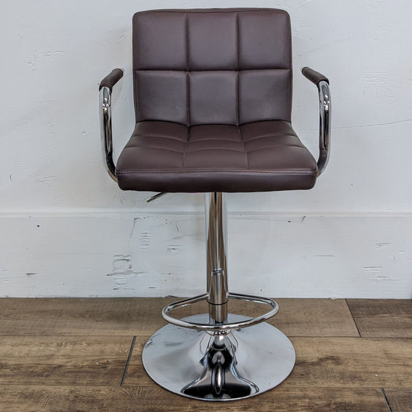 Brown leather look swivel stool with arms, chrome base, front view.