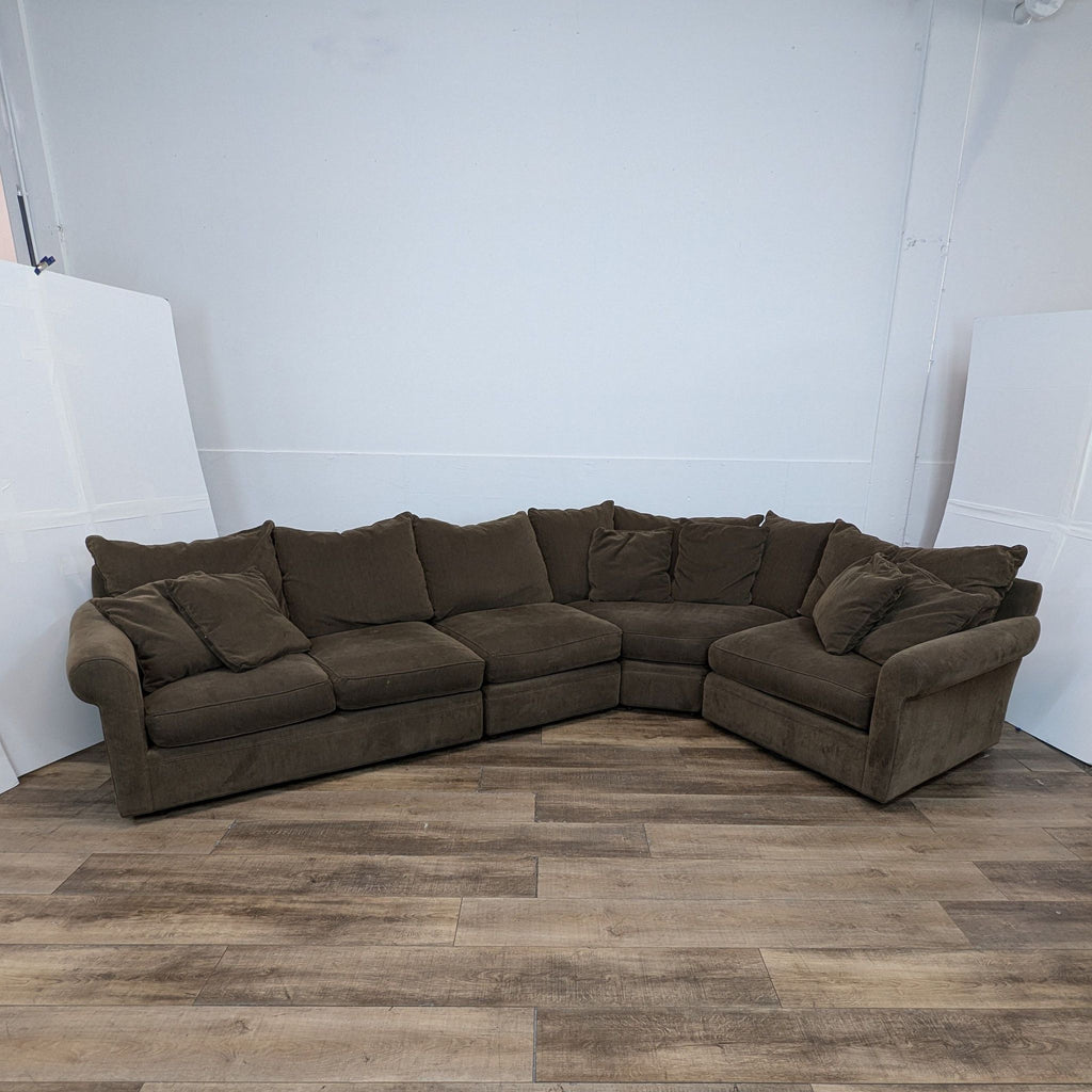 BluDot Room and Board brown sectional on wooden floor.