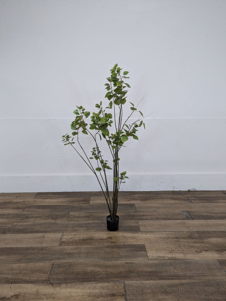 a large artificial plant in a black pot