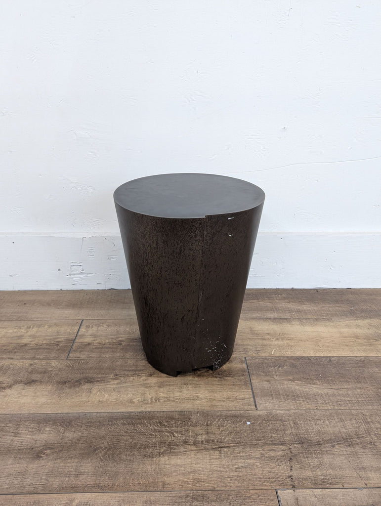 a black concrete side table with a black base.