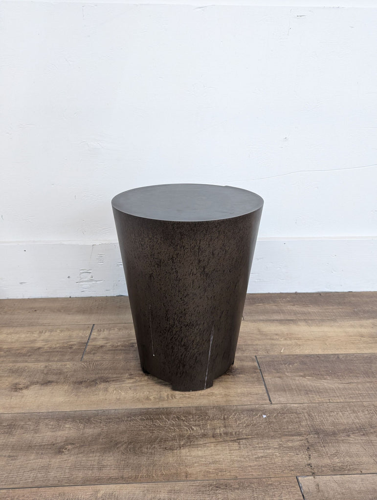 a large black round side table with a metal base.