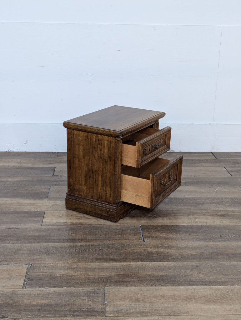 a mid century modern bedside table with drawers