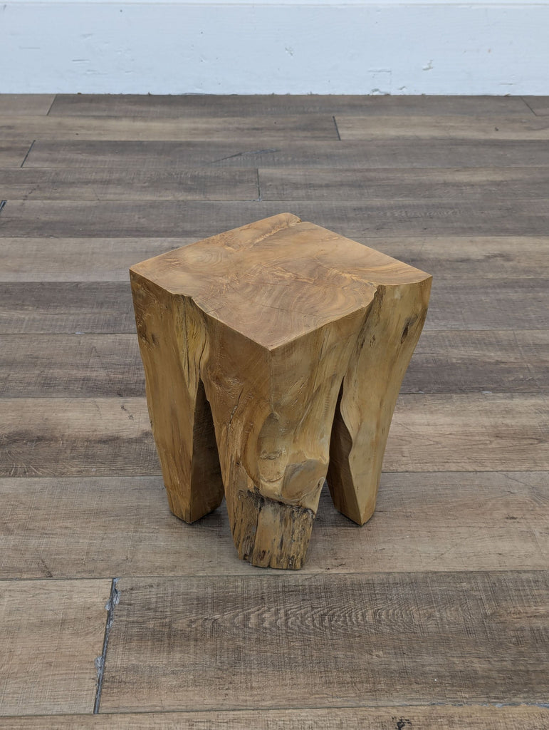 a square shaped wooden table with a square base.