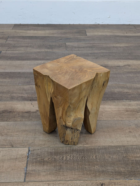 a square shaped wooden table with a square base.