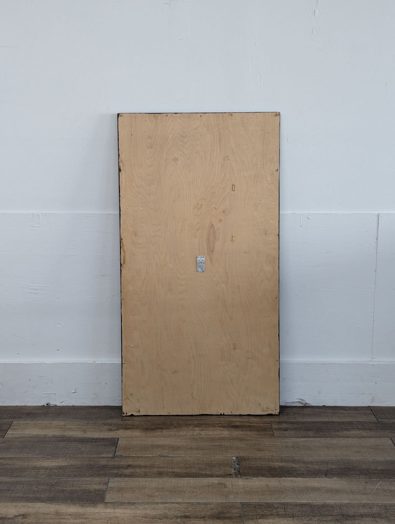 a large wooden board against a white wall.