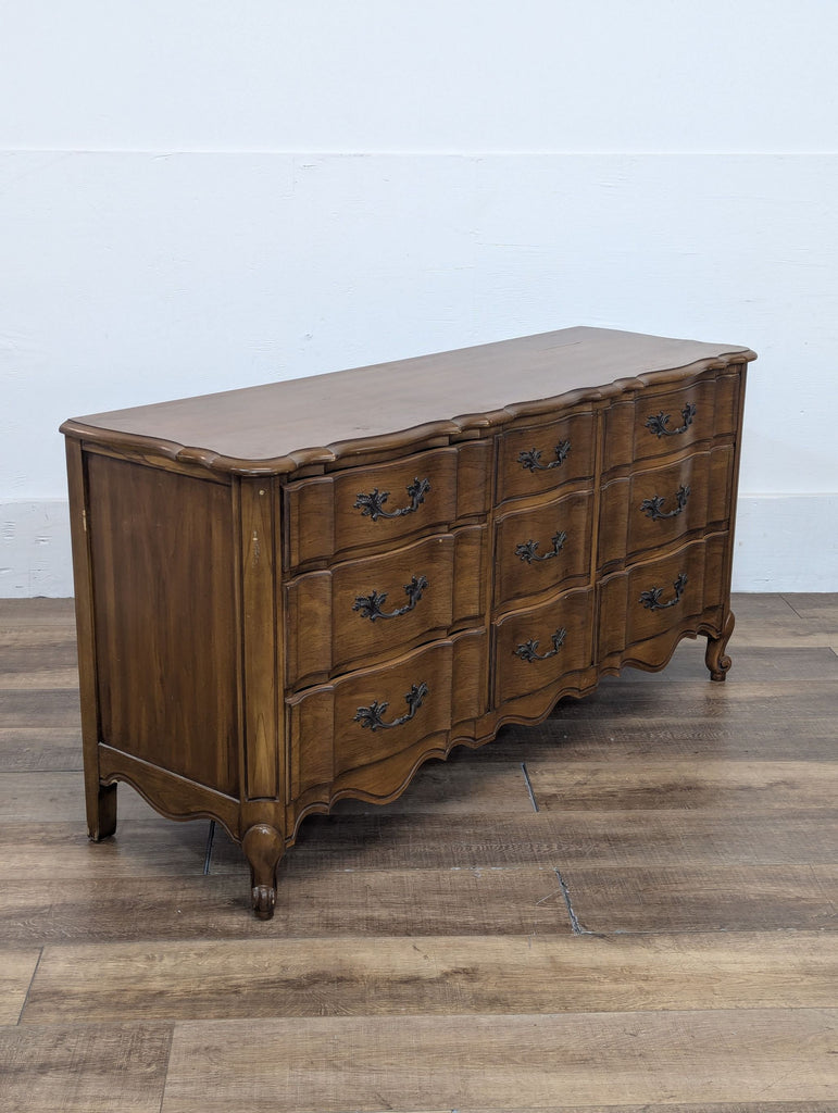 2. Side angle of a classic White Fine Furniture dresser, showing elegant molding, carved legs, and multiple drawers.
