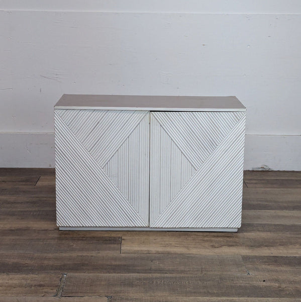 Halsey cabinet with geometric design, viewed from the front with closed doors.
