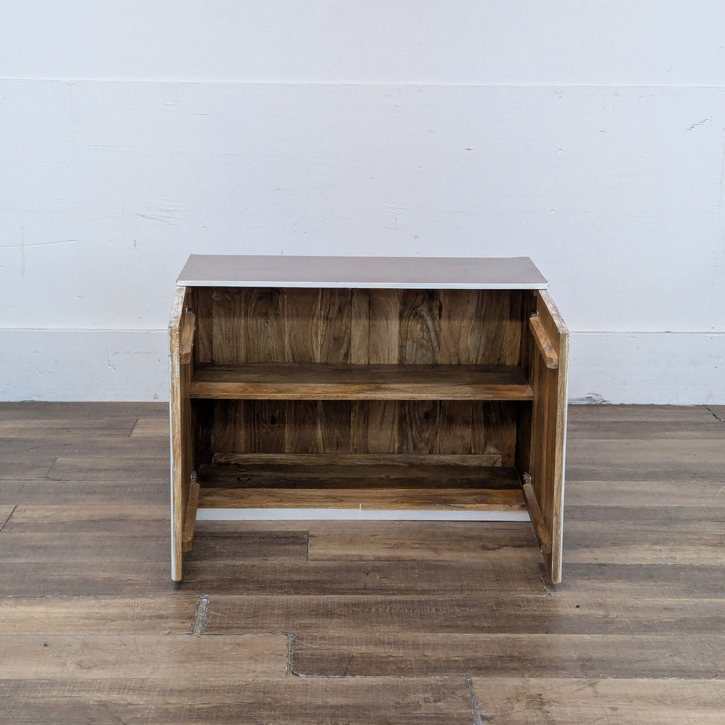 Interior view of the Halsey cabinet showing wooden shelves with doors open.