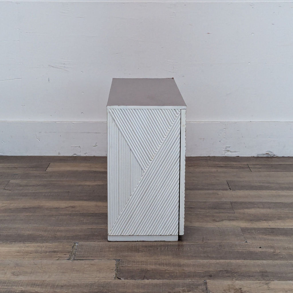 Side view of the Halsey cabinet highlighting its textured design and compact shape.