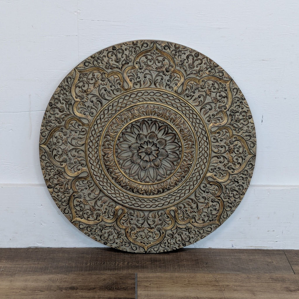 2. Front view of a circular Reperch wall decor featuring elaborate gold and grey floral designs.