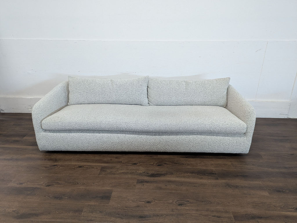 2. Reperch 3-seat sofa in light grey fabric, featuring soft cushions and rounded sides, placed on wood flooring.