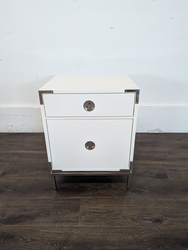 3. Single white West Elm end table with metal trim and two storage sections, against a plain background.