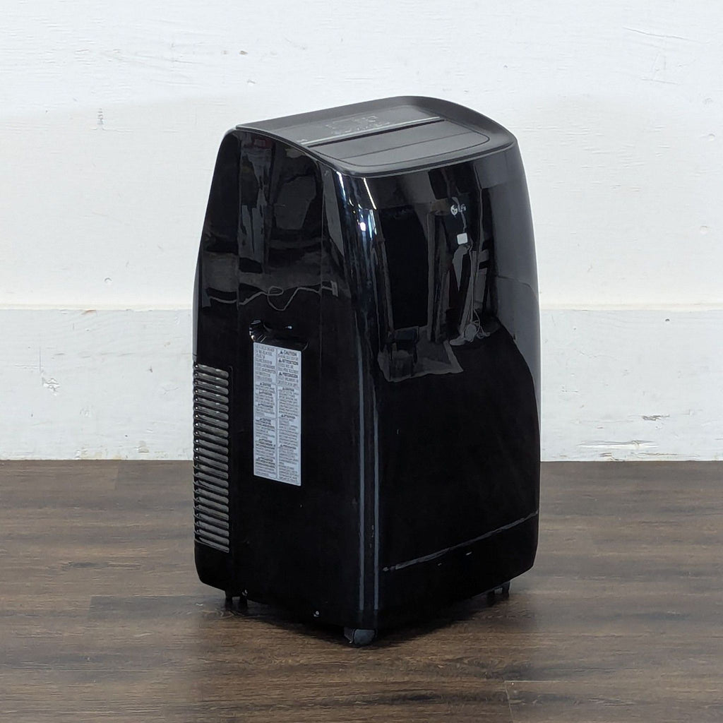 3. Angled side view of a Reperch portable black air conditioner, positioned on a wooden floor.