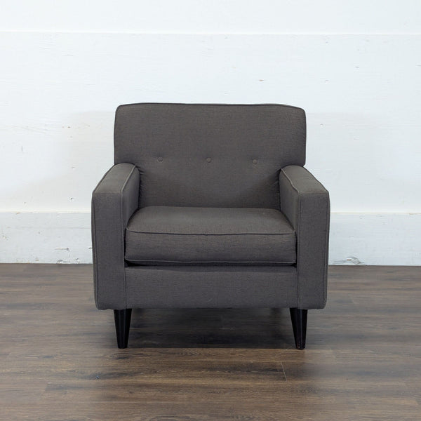 1. Front view of a dark gray Reperch lounge chair with button-tufted back and straight armrests.  