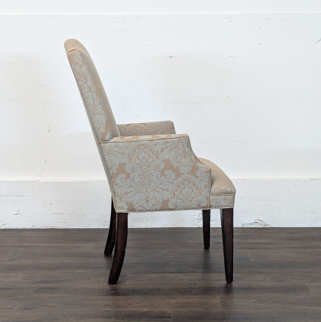 3. Profile view of Reperch armchair, featuring elegant damask upholstery and slightly curved wooden legs.