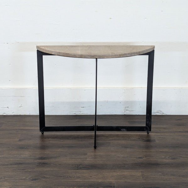 1. Reperch half-moon accent table with a light wood top and black metal legs, shown from the front.