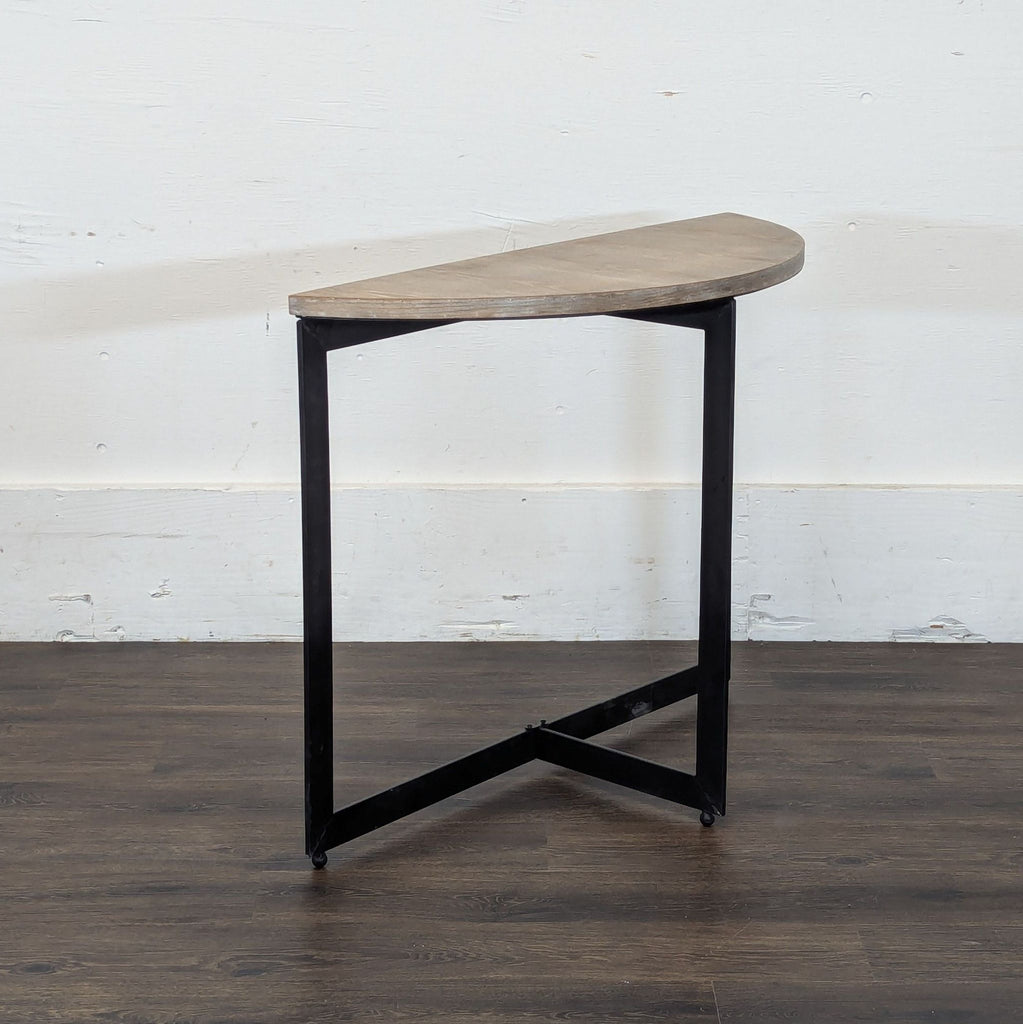 2. Side angle view of a Reperch semicircle table with slender black metal base, category Other.