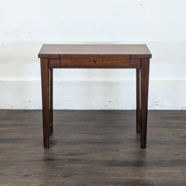 1. Reperch side and console table in dark wood, features one center drawer, shown against a white wall.  