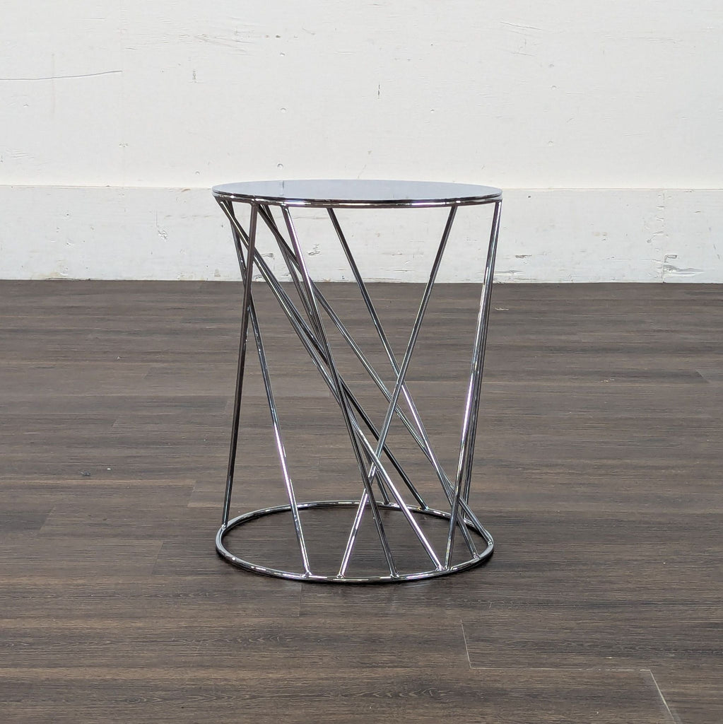 1. Modern Reperch end table with round mirrored top and crisscross chrome metal base on wood floor.