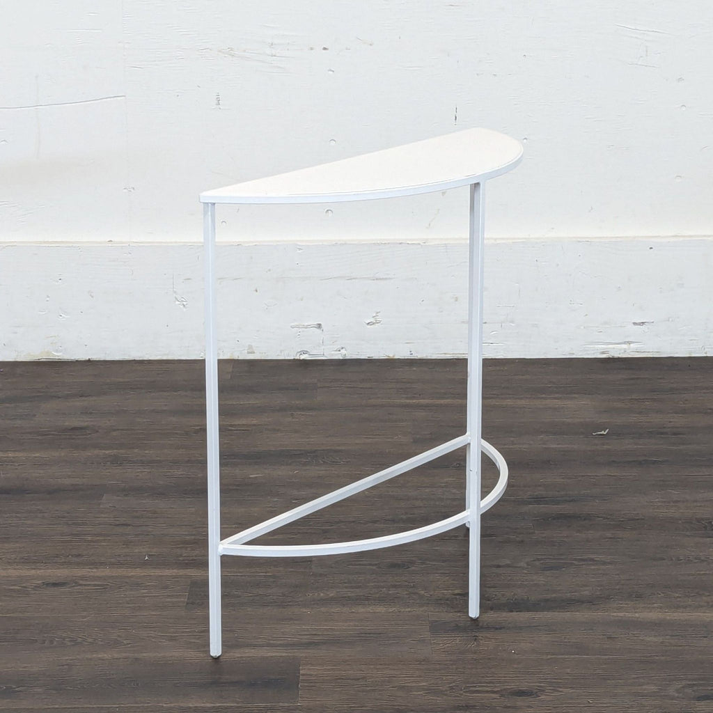 3. Side view of a slim, white semicircular Reperch table with minimalist legs and frame, category Other.