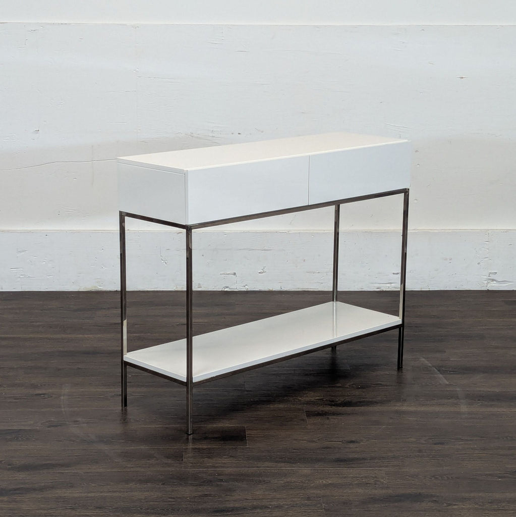 2. Angled view of a Reperch console table, featuring minimalist white drawers and a metal frame with shelf.