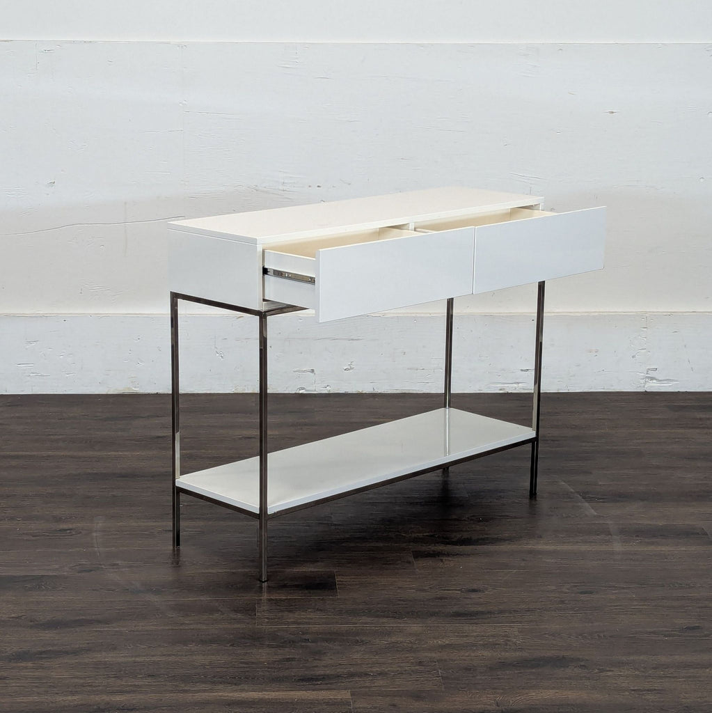 3. Reperch side table with two open white drawers, slim metal legs, and a lower storage shelf.