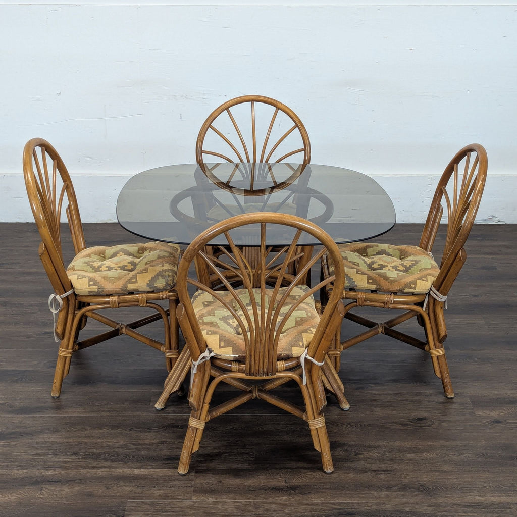3. Reperch brand dining set featuring a glass table and four rattan chairs, displayed on a wood floor.