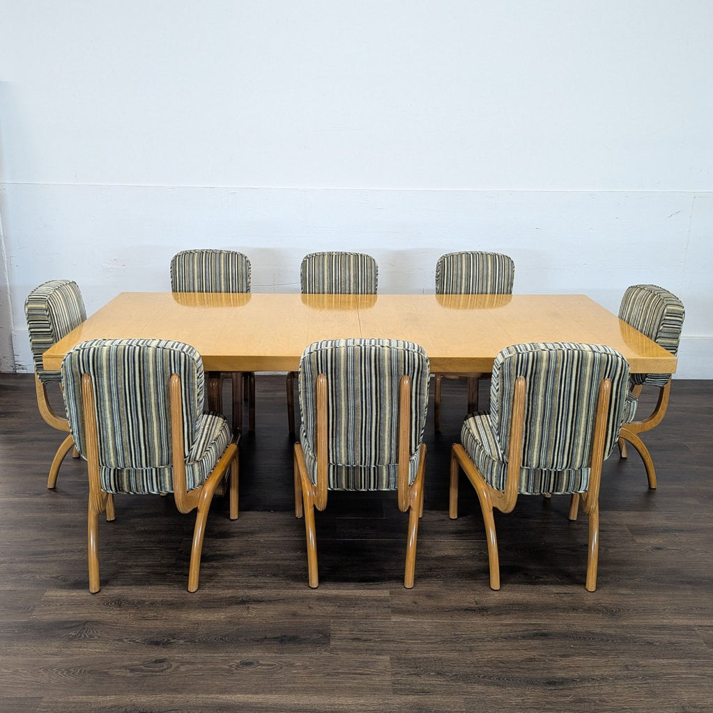 2. Eight striped upholstered chairs around a large Reperch dining table, shown on a dark wood floor.