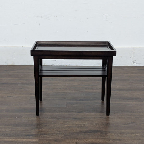 1. Dark wooden Reperch side table with raised edges and slatted lower shelf, shown from the front.