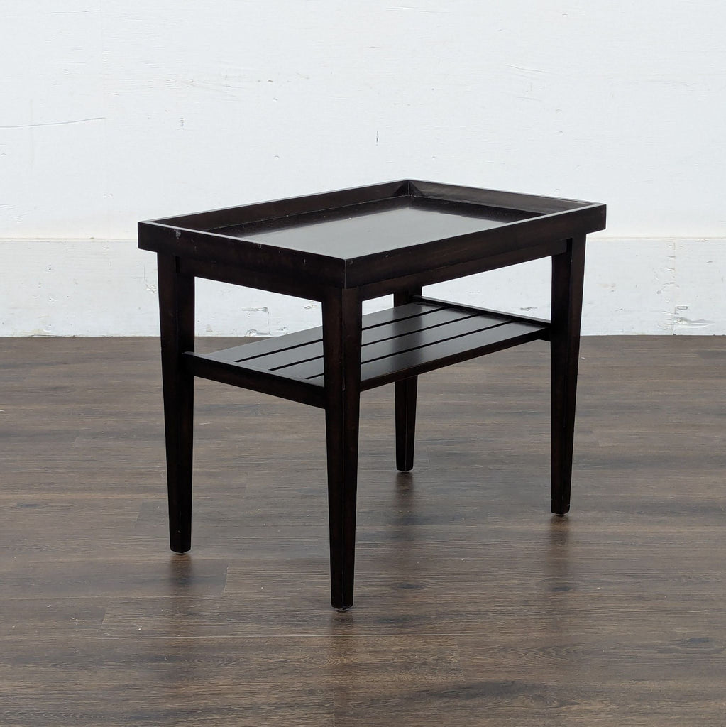 2. Angled view of a Reperch console table, featuring tapered legs and a rectangular top with a lower shelf.