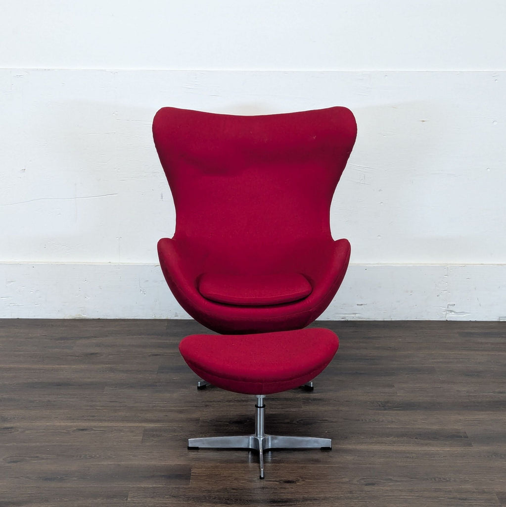Red Reperch lounge chair with cushioned seat and ottoman on silver legs, shown on a dark wood floor.