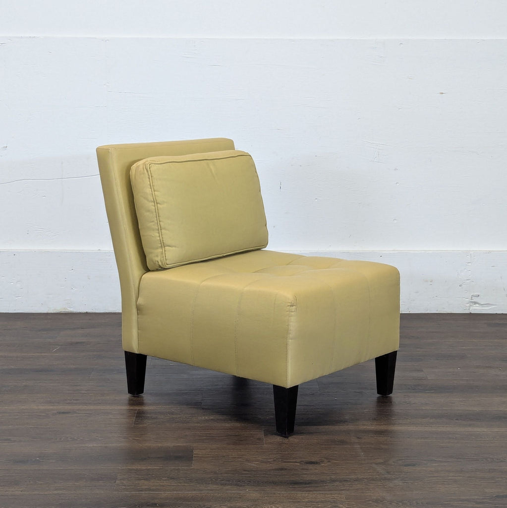 2. Angled view of a light yellow Reperch lounge chair showing cushioned back and seat, set on dark wooden legs.