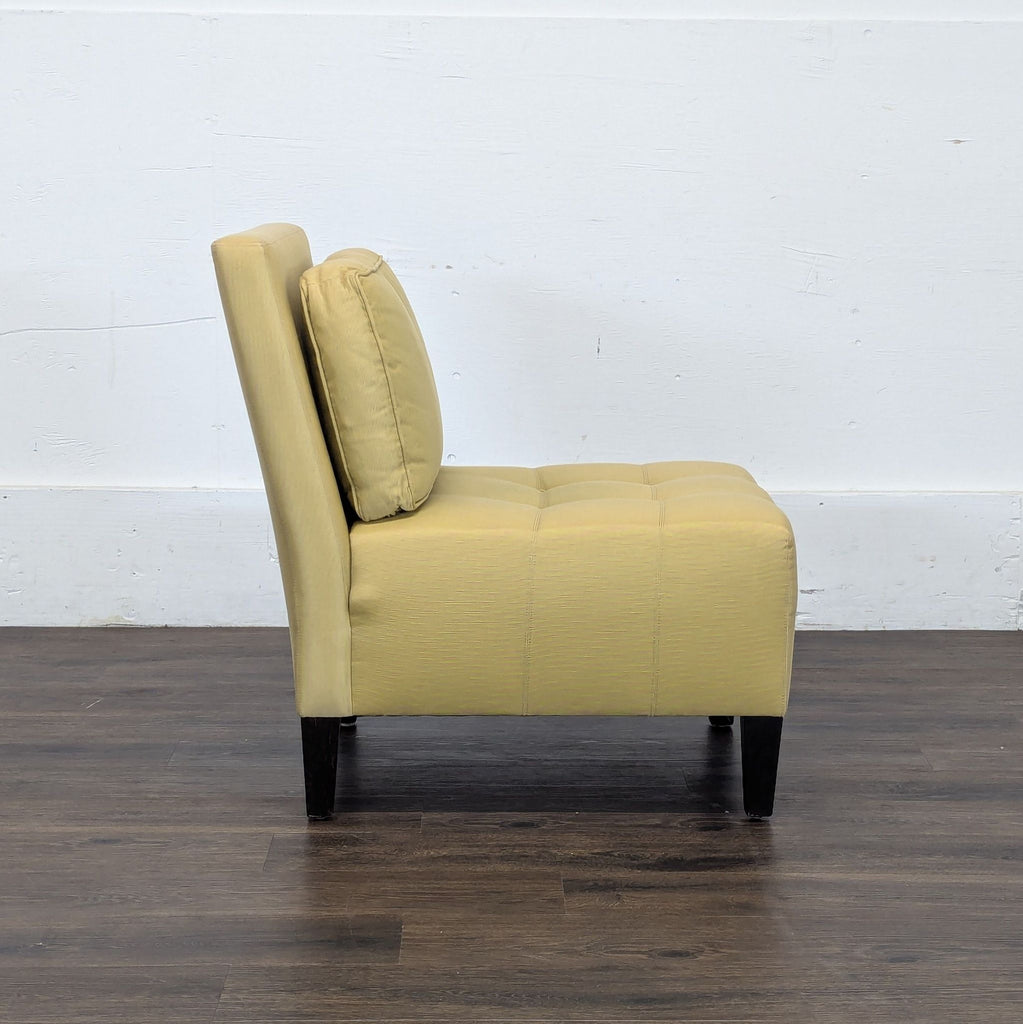 3. Side view of a Reperch lounge chair in the Lounge category, featuring a padded cushion and sleek black legs.