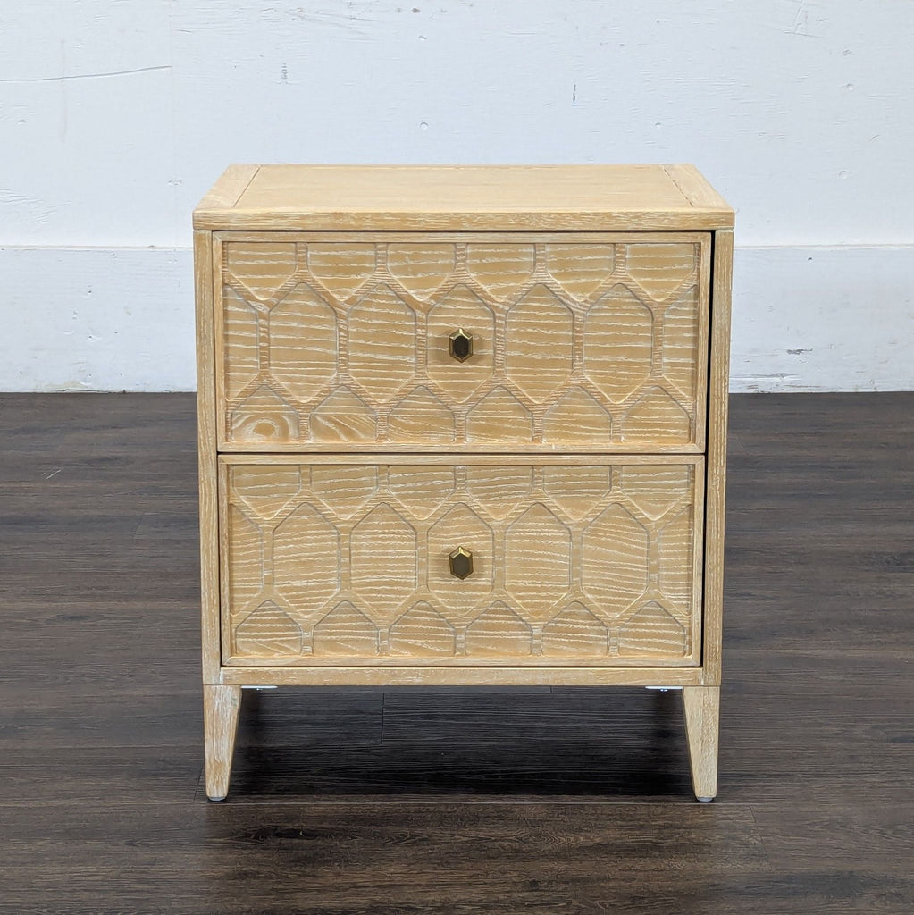 1. Reperch side table with two geometric-patterned drawers and gold knobs in light wood finish, front view.