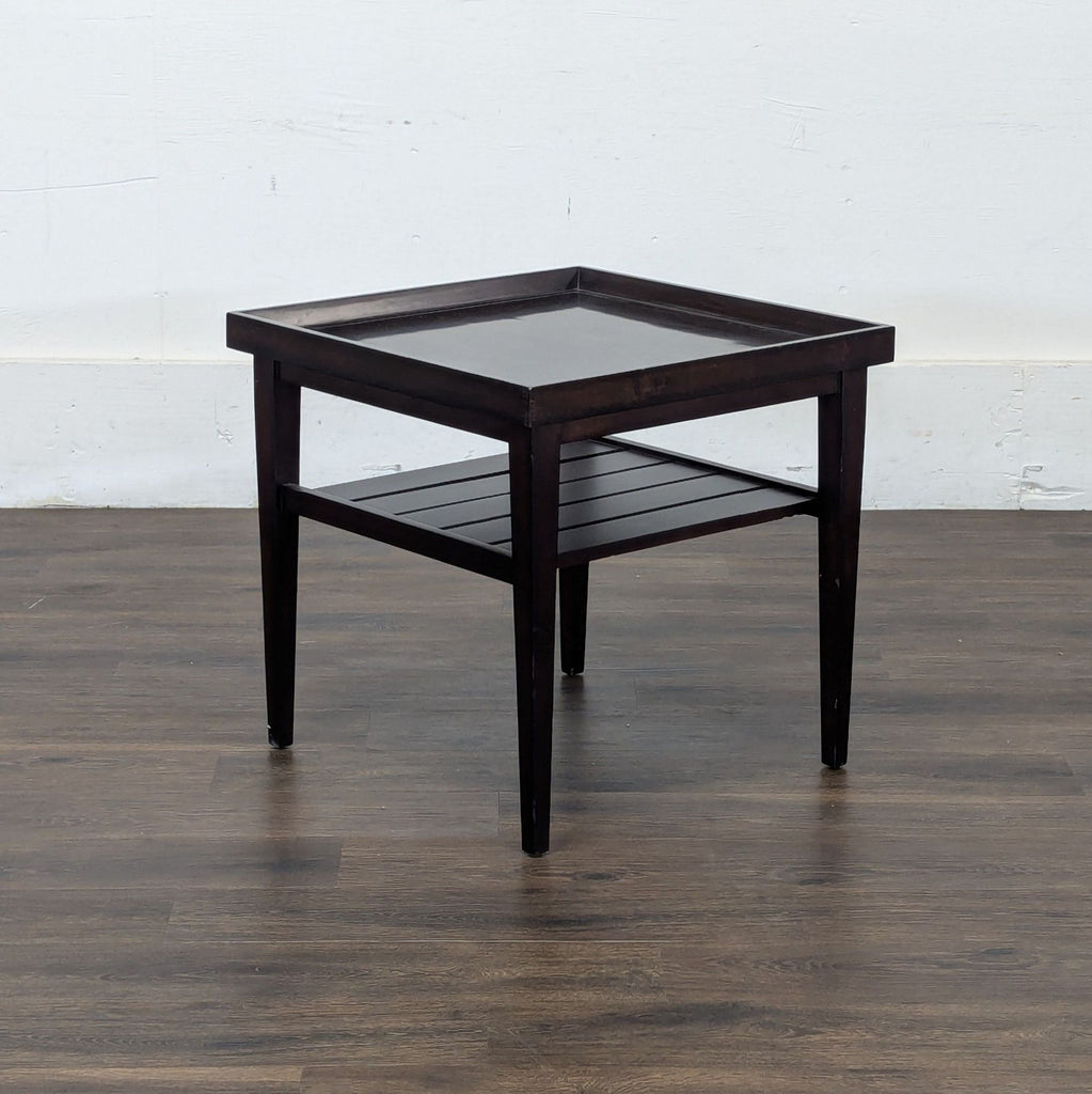 2. Angled view of a Reperch console table with raised edges and a lower slatted storage shelf.