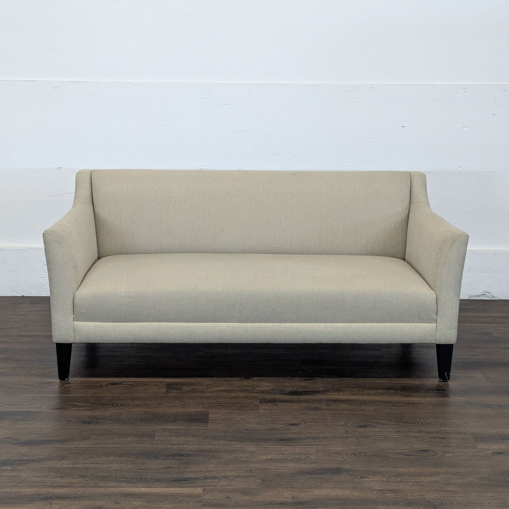 1. Front view of a Reperch brand beige loveseat with straight lines and dark wooden legs.