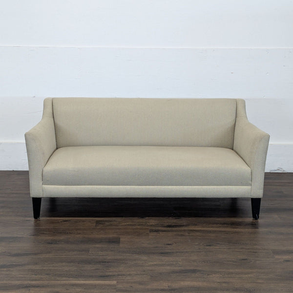 1. Front view of a Reperch brand beige loveseat with straight lines and dark wooden legs.