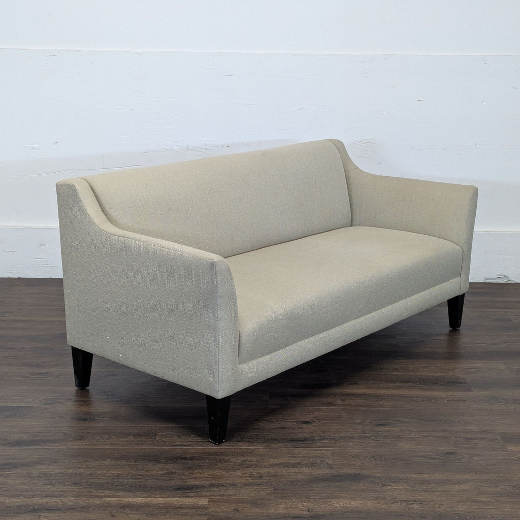 2. Angled side view of a Reperch beige loveseat, showing its cushioned seat, back, and armrest design.