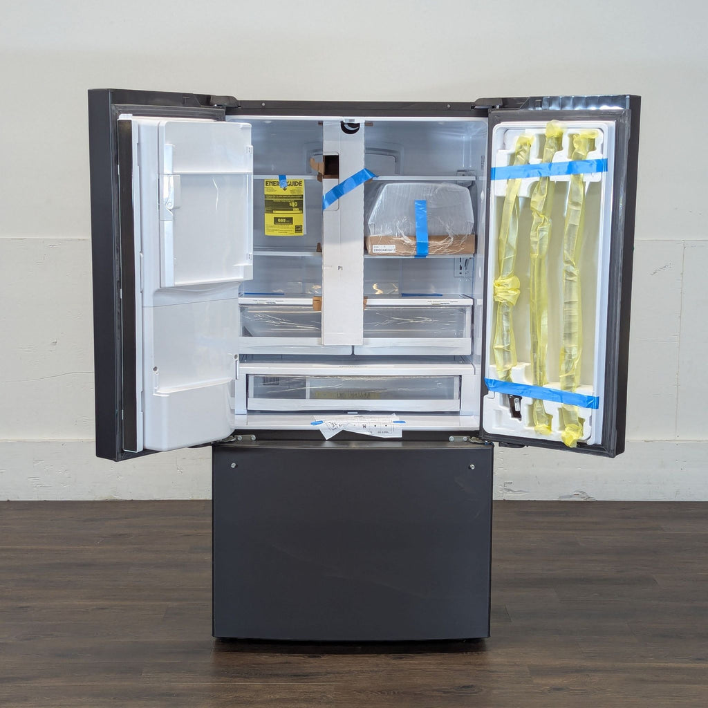 3. Open Reperch French door refrigerator showing spacious interior, storage bins, and packaging materials inside.