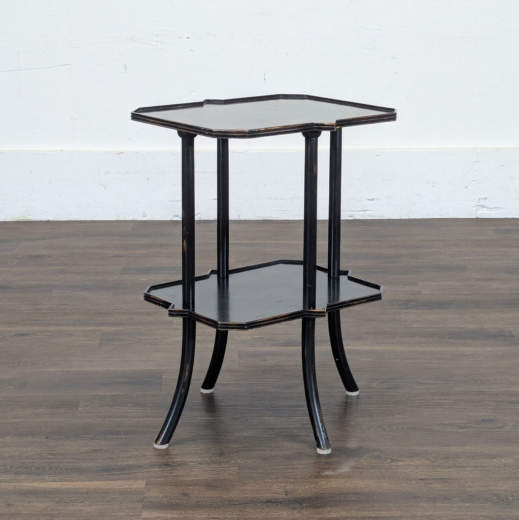 2. Reperch side & console table featuring a black finish, two scalloped shelves, and four curved legs.