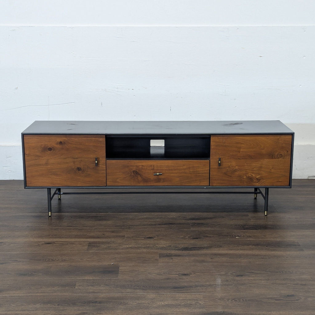 Empty West Elm or EQ3 entertainment center with wood and black finish, featuring cabinets and an open shelf.