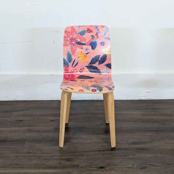 1. Reperch dining chair with a pink seat and backrest featuring a vibrant floral pattern, wooden legs visible.