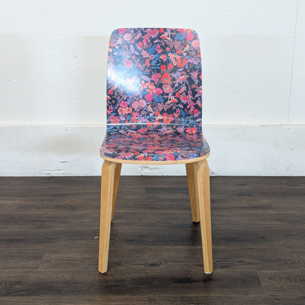 1. Reperch dining chair with curved wood legs and a seat-back covered in a vibrant, colorful floral pattern.